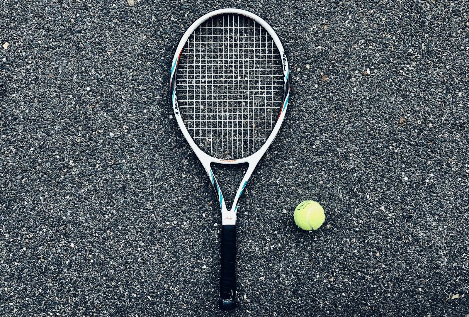 white tennis racket and green tennis ball